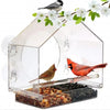 Clear acrylic bird feeder with suction cups and a perch, featuring a small bird and white flowers.