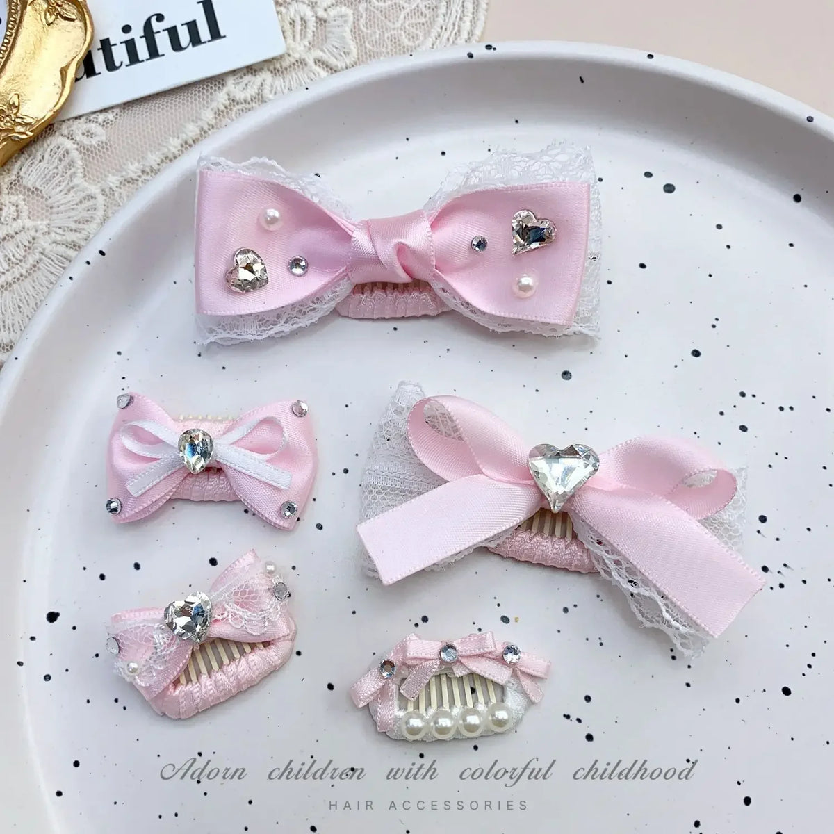 Pink bow hair accessories featuring rhinestones and pearl accents for children's hair