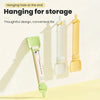 A long, clear plastic spoon with a green handle is shown hanging on a hook for storage.