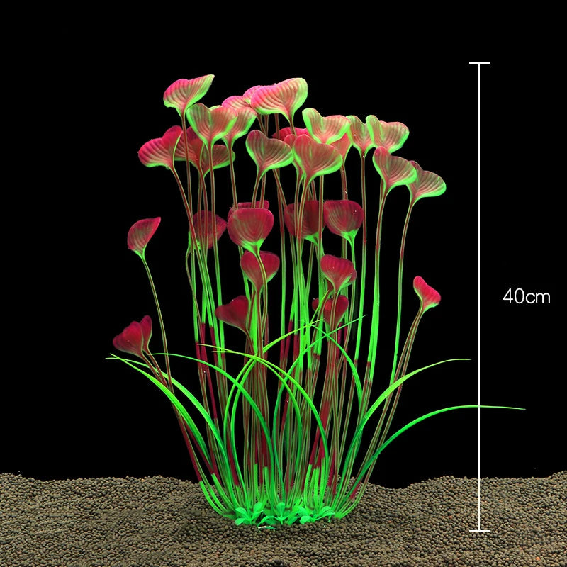 Un amas de plantes aquatiques artificielles réalistes avec des feuilles roses et rouges poussant à partir d'un substrat.