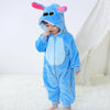 A baby wearing a blue cartoon animal hooded romper with pink ears and a hood.