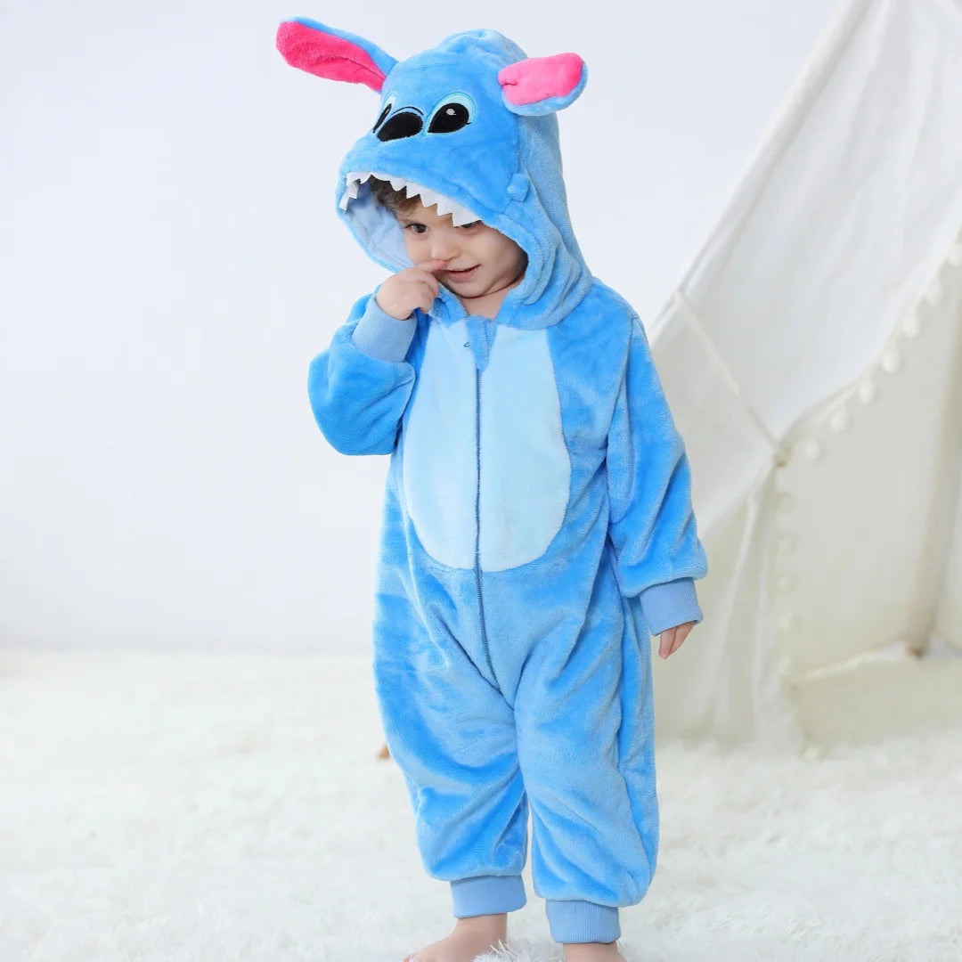 A baby wearing a blue cartoon animal hooded romper with pink ears and a hood.