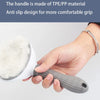 A hand is holding a gray anti slip handle of a pet hair removal brush with massage pins.