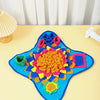 A bright blue snuffle mat with colorful fabric pieces for slow feeding puzzle toy.