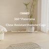 A chew-resistant hamster cage with a 360 degree panorama view shown in a bright indoor setting.