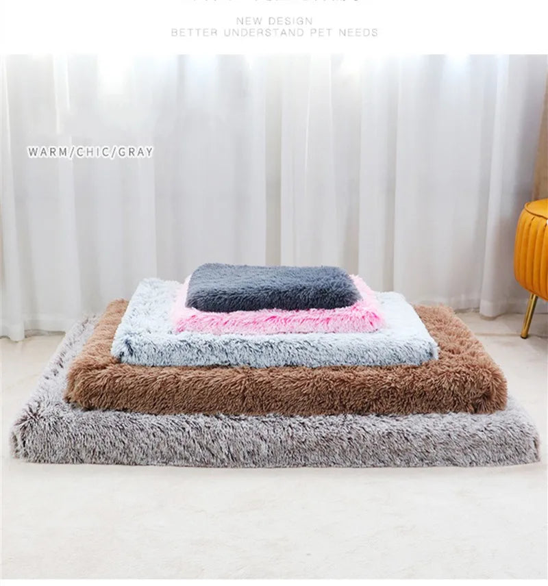 A stack of ultra plush orthopedic rectangular dog beds in shades of gray, brown, and pink on a white floor.