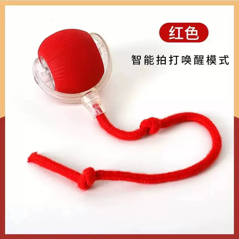 A red, motion-activated smart pet ball with a string attached for interactive play.