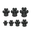 A pack of four black anti-slip dog paw grips in various sizes labeled XL, XXL, XXXL, S, M, and L.