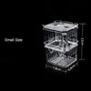 A clear acrylic fish breeding isolation box with a grid bottom and a lid, shown against a black background.