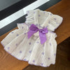 A white and purple textured dress with a lavender bow detail for a cute strawberry dog.