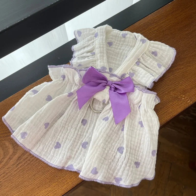 A white and purple textured dress with a lavender bow detail for a cute strawberry dog.
