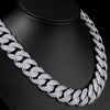 A close-up of a silver-toned Cuban link necklace with a curved flip buckle design displayed on a black display stand.