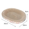 A beige cat scratching post with a textured surface and a decorative floral rim.