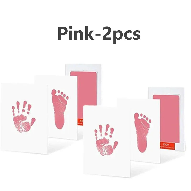 Two pink baby handprint and footprint kits displayed on a white background.