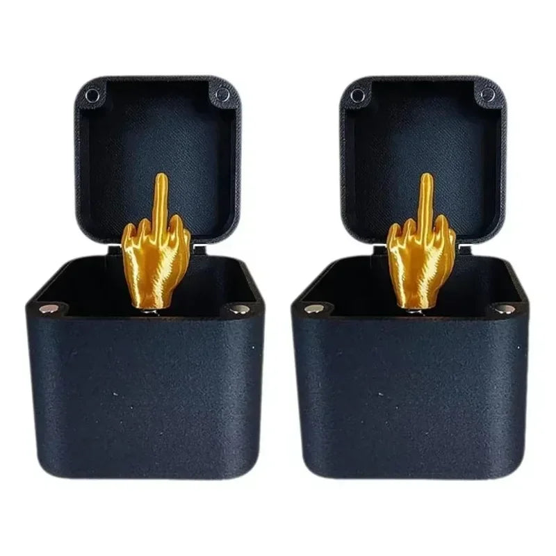A pair of dark blue wooden prank boxes with gold hand figures inside.