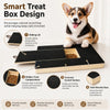 A brown and white dog is sitting on a black wooden board designed for natural nail scratching and treats.