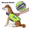 A brown dog wearing a neon yellow rescue handle life jacket with a black strap and reflective stripes.