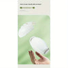 A white semi-circular lint roller handle is shown being used by a hand.