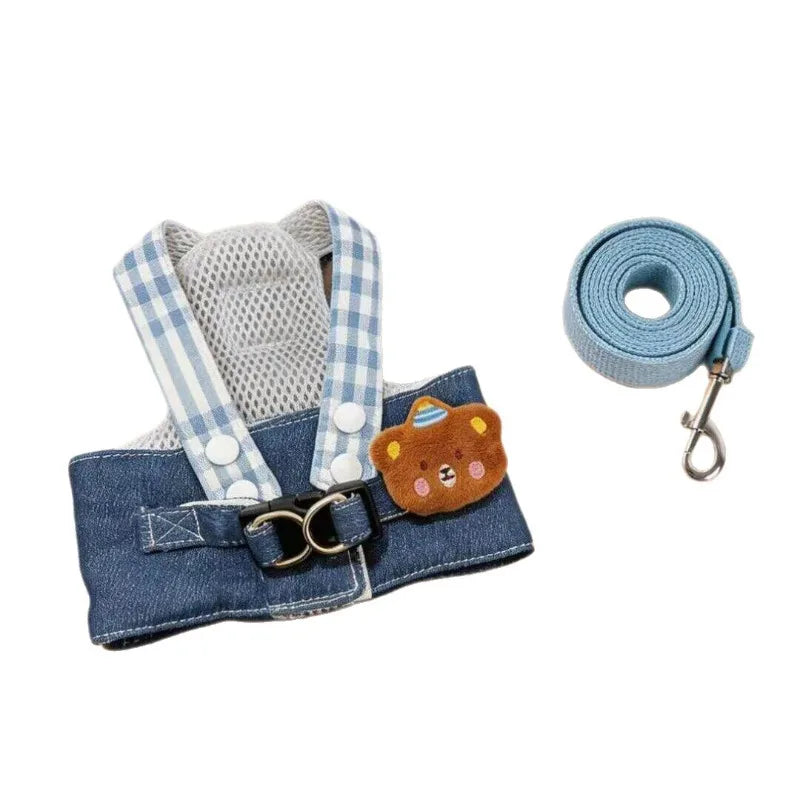 Blue and white plaid dog harness vest with a fluffy cartoon dog head and attached leash.