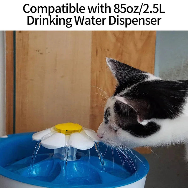 A cat is drinking water from a blue pet fountain, which is compatible with an 85oz or 2.5L dispenser.
