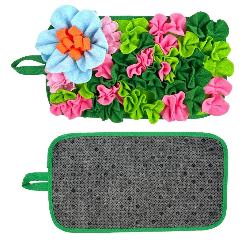 A mat featuring colorful fabric flowers in shades of blue, pink, and green for interactive pet foraging.
