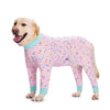 A golden Labrador dog wearing a pink cartoon print cotton pajama top and pants.