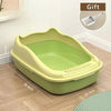 A lime green high-sided cat litter box with an anti-splash design sitting on a wooden floor.