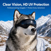 A husky dog wearing black HD UV protection goggles in a snowy mountain landscape.
