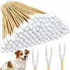 A bundle of long cotton swabs is shown next to a dog.
