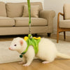 A white cartoon animal vest harness for pet training is lying on a wooden floor.