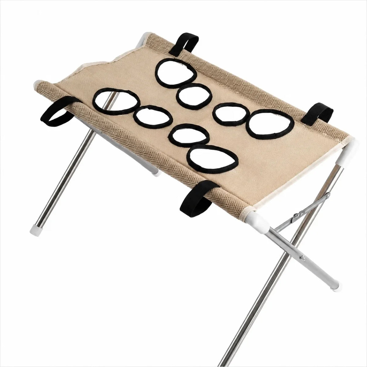 Hamaca plegable beige para aseo de mascotas con anillos negros para cortar uñas, soportada por un marco de metal.
