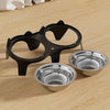 A black anti-tip stainless steel double pet bowl is shown on a light wooden surface.
