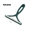 A dark green silicone pet hair and lint remover tool with a handle and a flat cleaning plate.