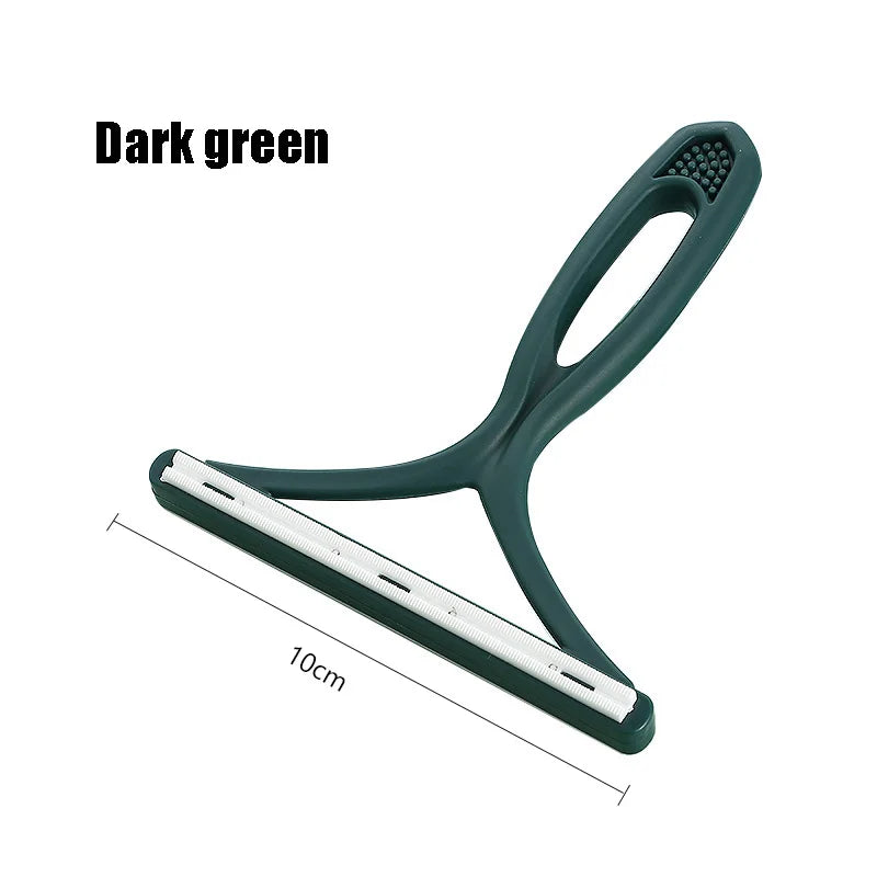 A dark green silicone pet hair and lint remover tool with a handle and a flat cleaning plate.