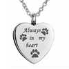 A silver stainless steel heart-shaped necklace with paw prints engraved on it.