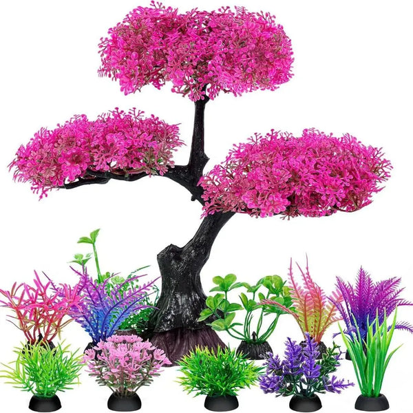 Eine Anordnung realistischer künstlicher Aquariumpflanzen in verschiedenen Rosa-, Violett- und Grüntönen.