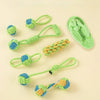 Several green and blue rope ball dog toys are displayed on a light background.