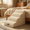 A beige pet safety climbing stairs product resting on a light-colored rug next to a wooden bed.
