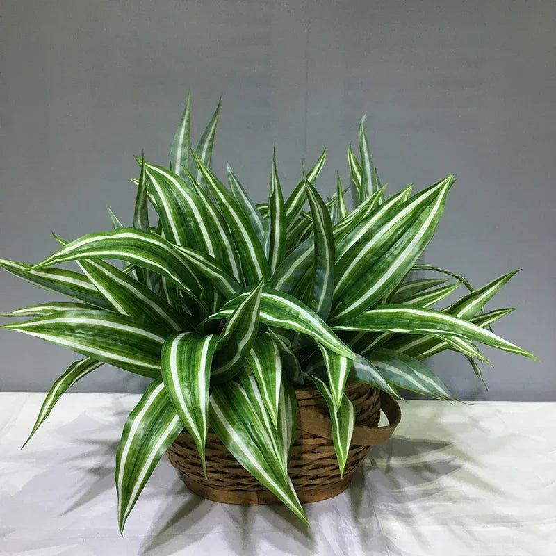 A vibrant green artificial tropical palm plant with striped leaves potted in a woven basket.