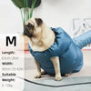 A light blue pet drying bag is shown with a pug dog sitting on a floor.