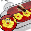 A red and clear hummingbird feeder with a yellow flower design and a bee flying near the nectar reservoir.