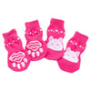 A pack of four bright pink anti-scratch cotton pet socks for small dogs and cats