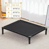 A black portable folding pet bed with a removable cover is displayed on a light carpet.