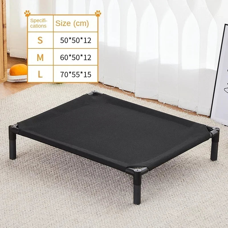 A black portable folding pet bed with a removable cover is displayed on a light carpet.