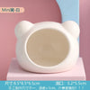 White ceramic hamster house featuring a bear design, shown in a studio setting.