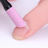 A pink glitter nail file tool is being used on a person's fingernail.