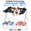 Una mesa de aseo para mascotas plegable negra con patas plateadas, mostrada junto a opciones azules, rosas y negras.
