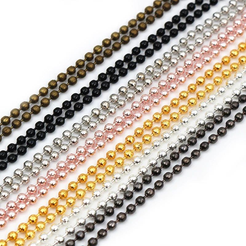 A set of graduated ball bead necklaces in various colors including gold, rose pink, silver, and black.