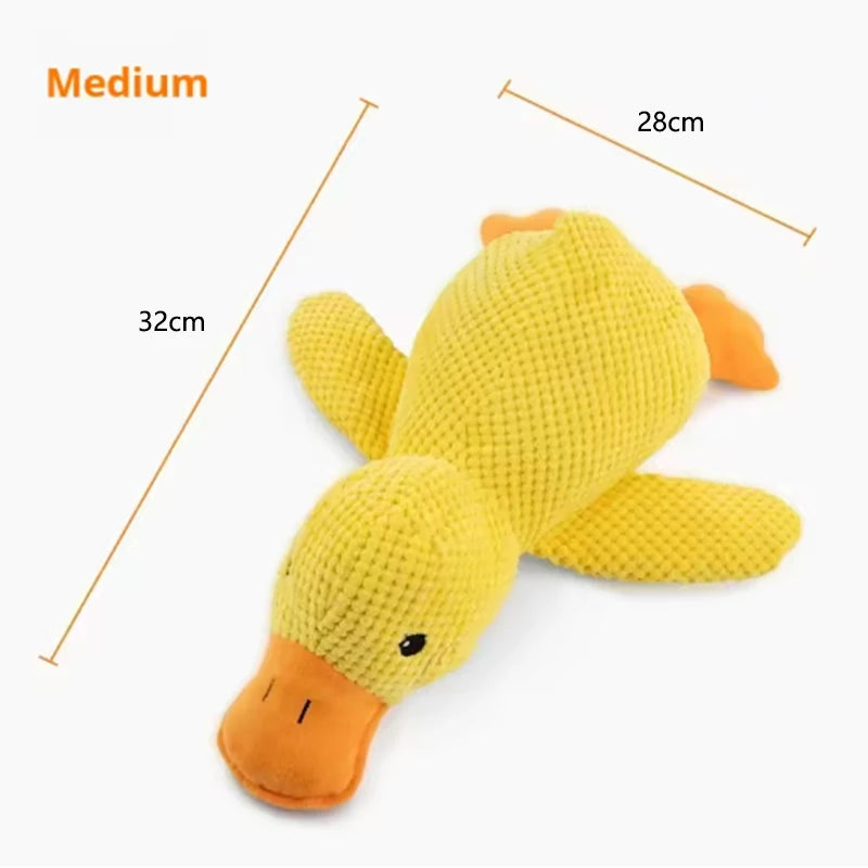A yellow plush duck toy with orange accents, shown from above.