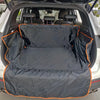 Black waterproof pet car seat cover laid out in the trunk of a white SUV.